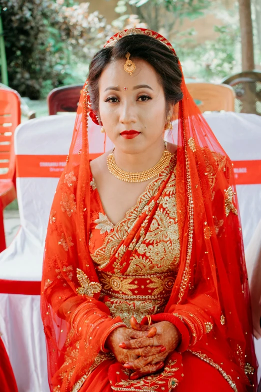 a bride in a red dress and veil
