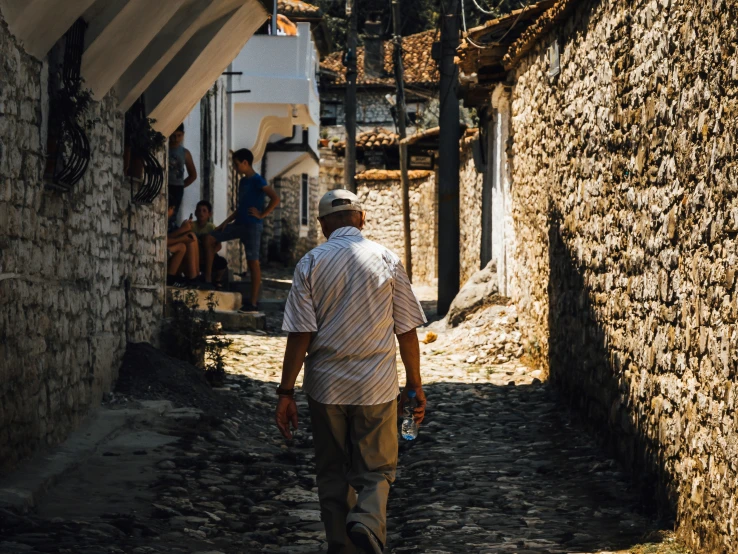 this man is walking in the middle of a narrow alley