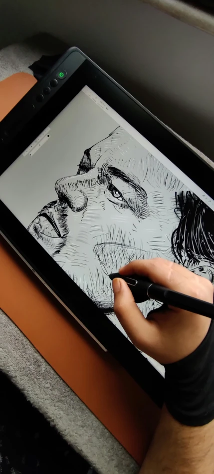 someone is drawing on an open tablet