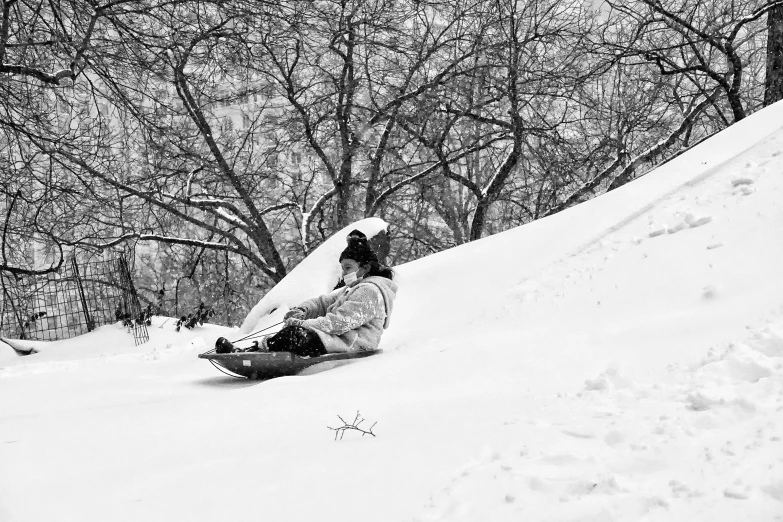 a snowboarder slides down a hill in the winter