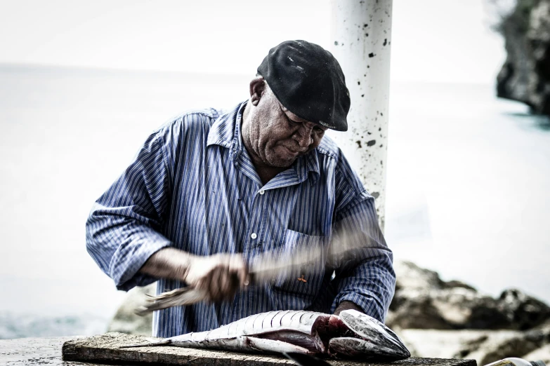 the man is peeling a fish out of the ground