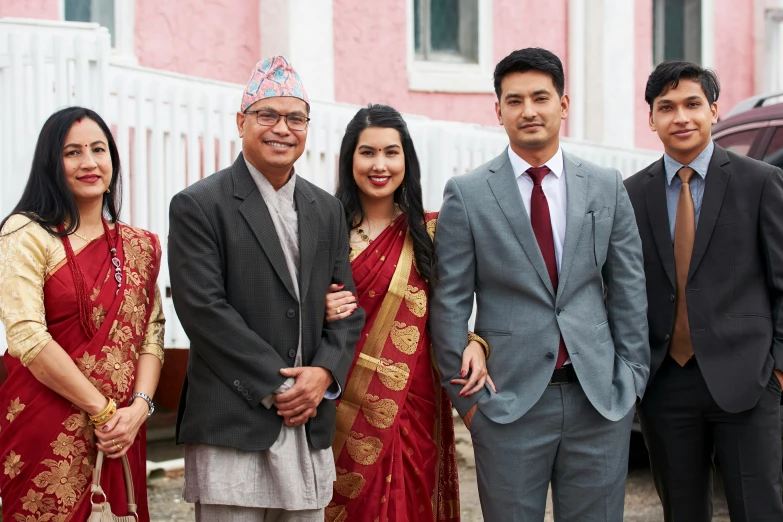 four people dressed in traditional asian clothing posing for a po