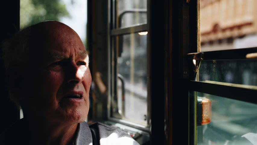 a woman looking out the window of a bus