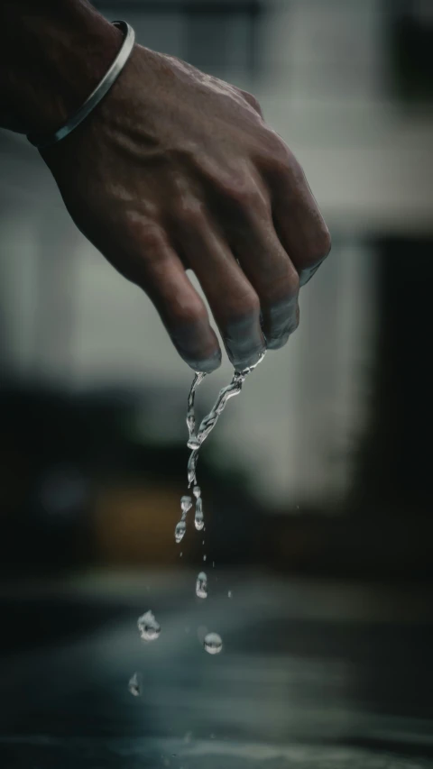 a person holding water and pouring it into a water container