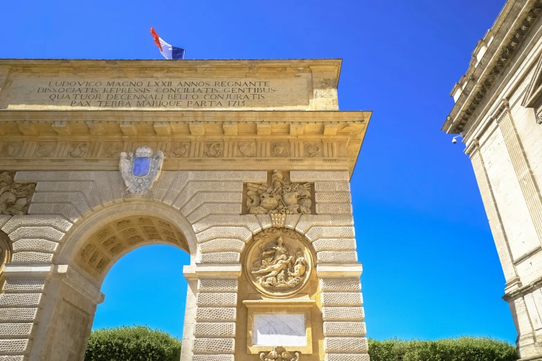 an archway leading to two flags near each other