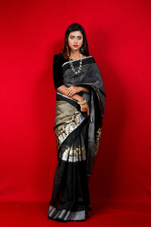 woman posing for the camera, in a sari