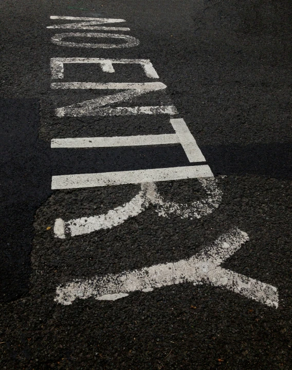 a bus stop sign is painted on the pavement