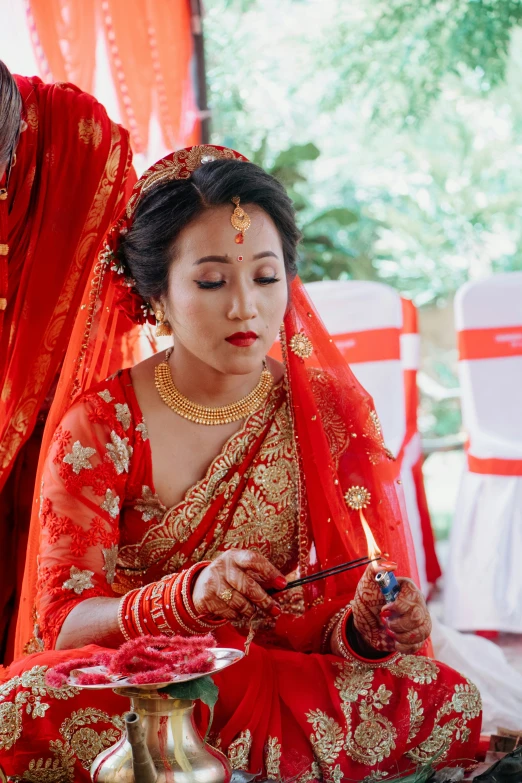 a bride with makeup and jewelry is sitting down