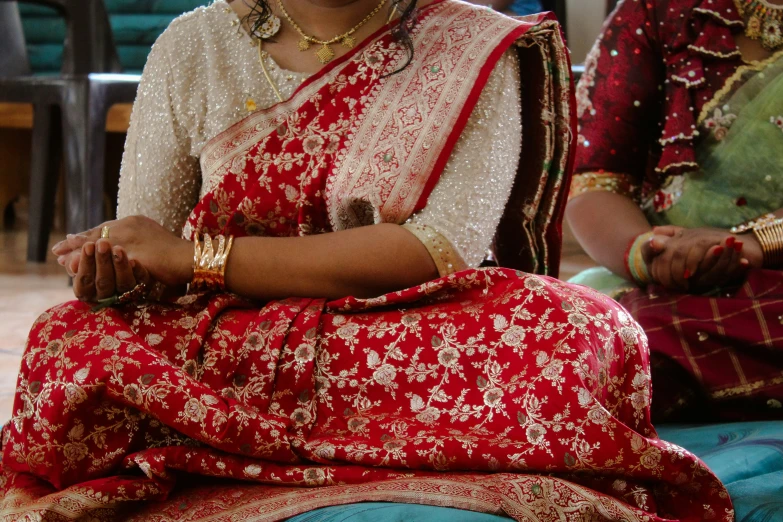 two indian women wearing elaborate jewelry on their heads