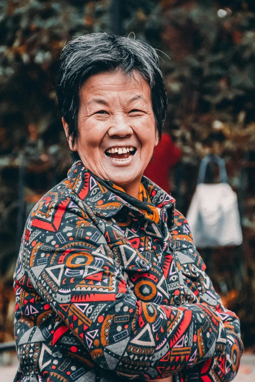 a woman with her arms crossed and smiling