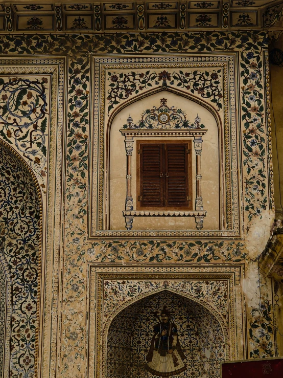 a wall and window with an oriental pattern