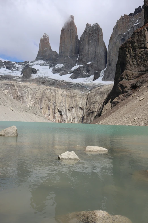 some rocks water and mountain and snow