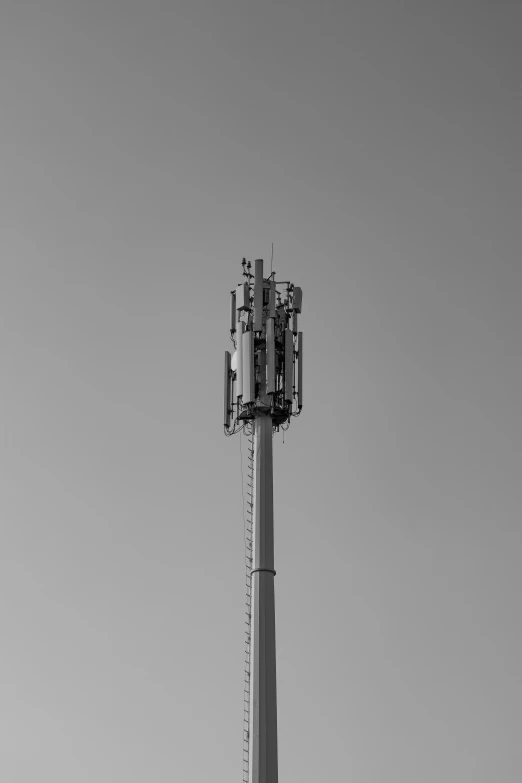 a tall tower with several telephone antennas on it