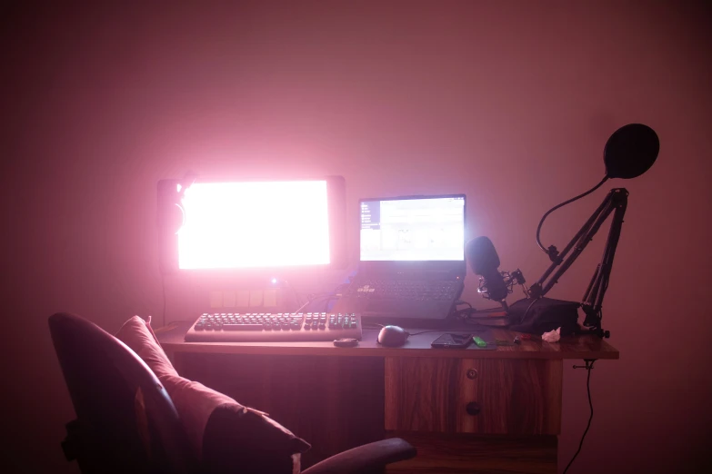 a computer and keyboard are sitting in a dim room