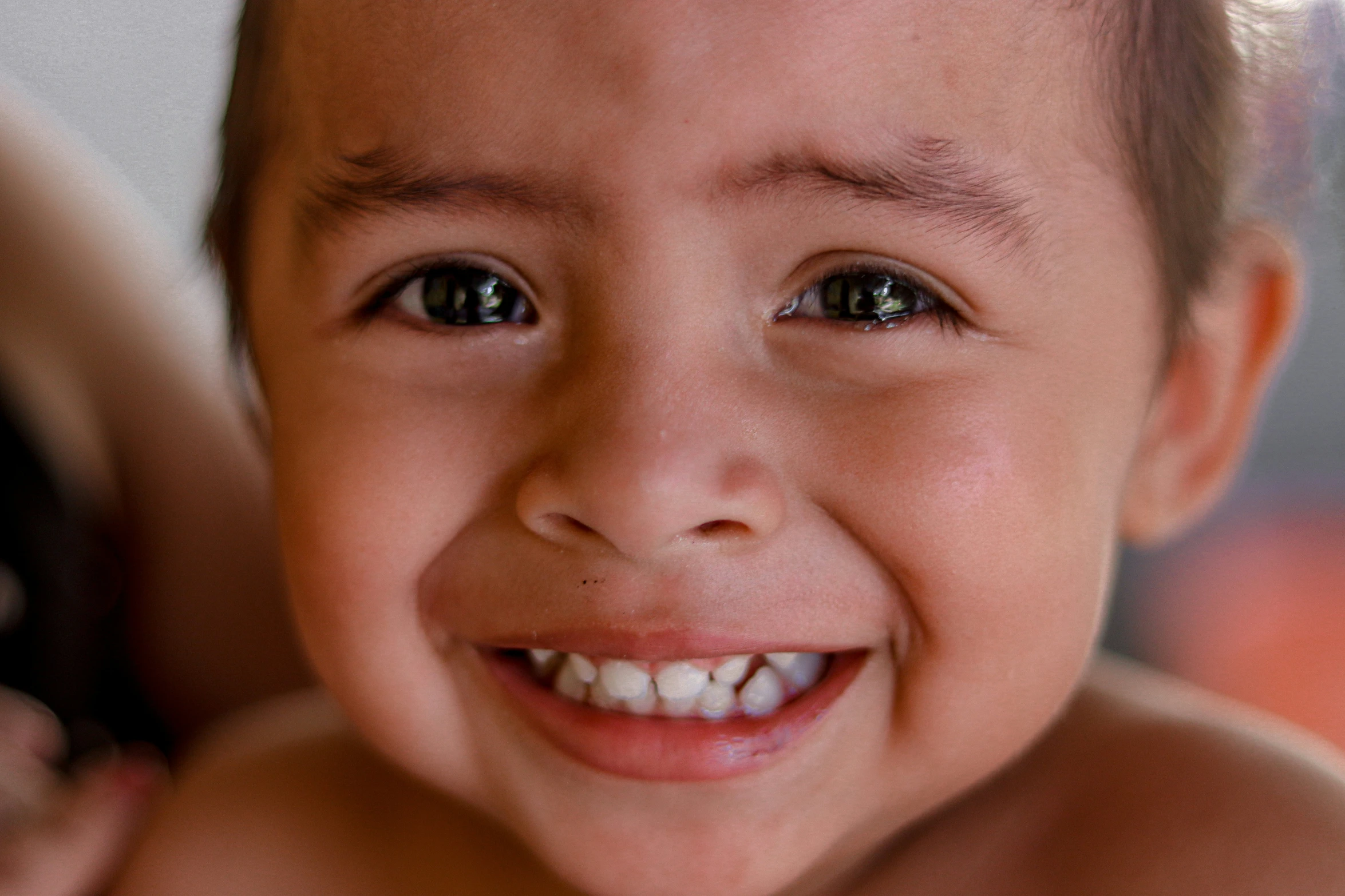 an adorable little boy smiling for the camera