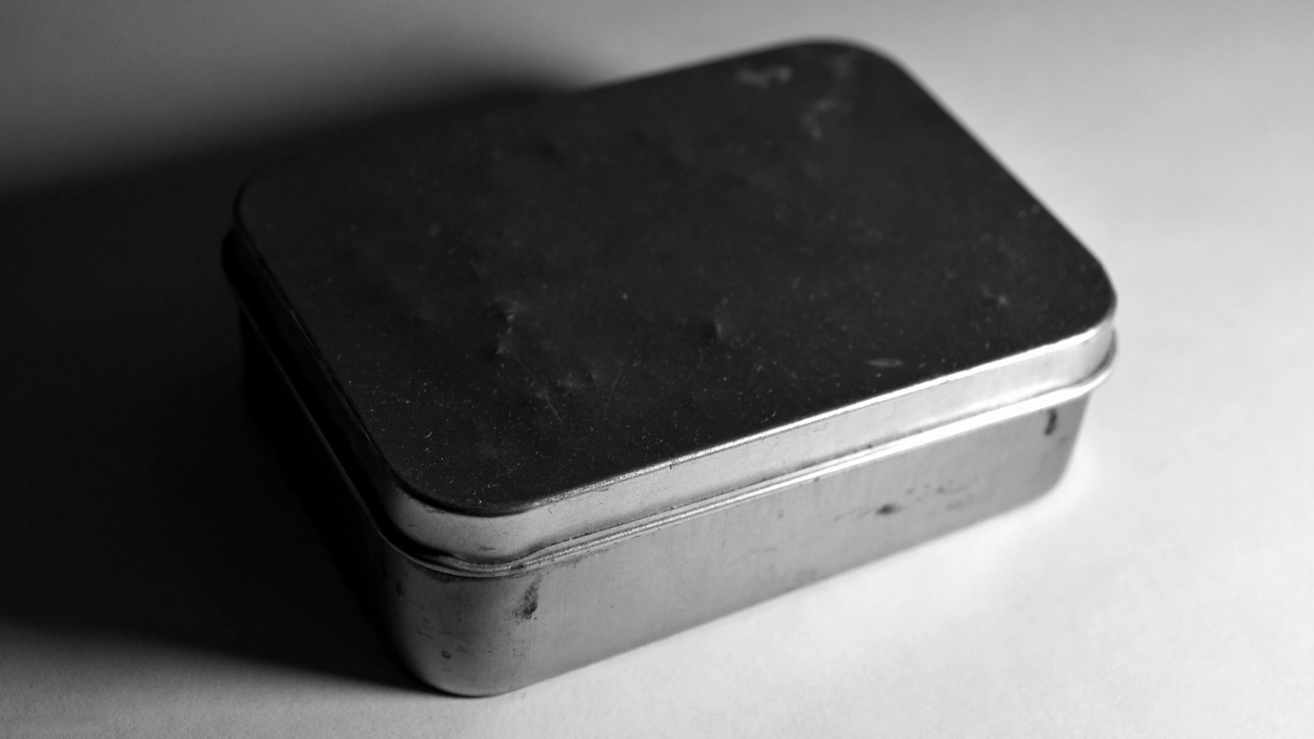 black and white pograph of an open tin can on a table