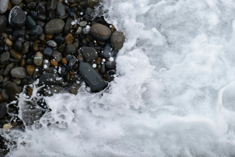 water splashing into the rocks on the shore