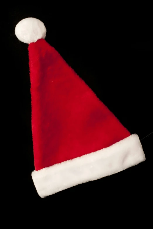 a red santa claus hat on black background
