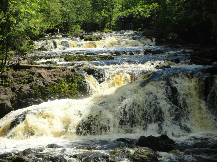 a long waterfall with water flowing over it