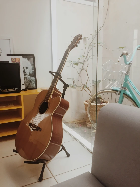 a guitar is leaning on an upright chair in front of the mirror