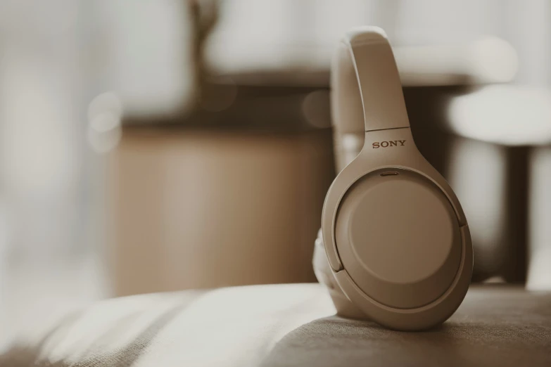 headphones resting on a bed with blurry background