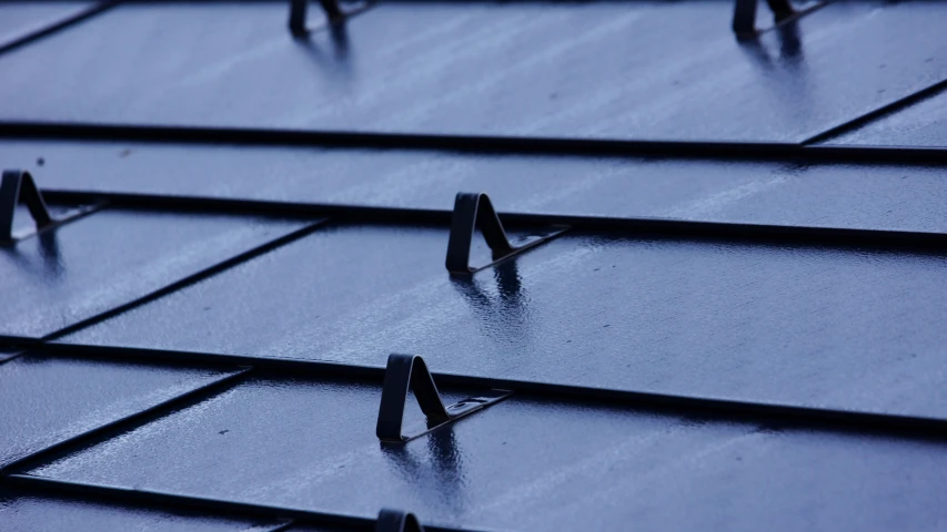a sky view of metal roofing that is dark and wet