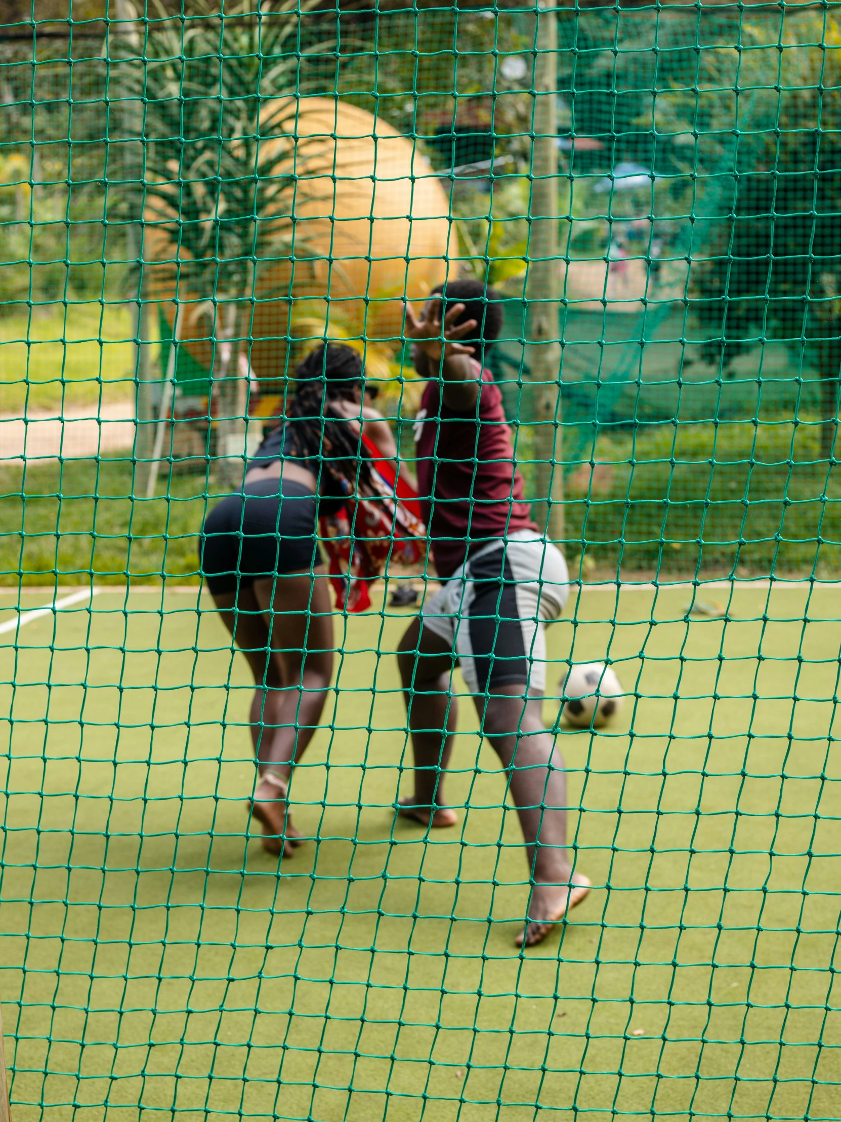 people on a baseball field in tights standing near the ball