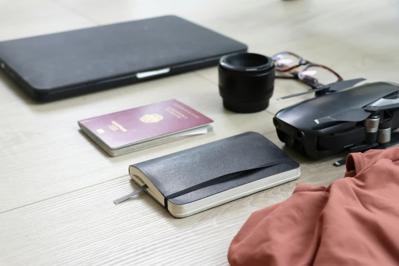 a travel camera and notebook sitting on a table