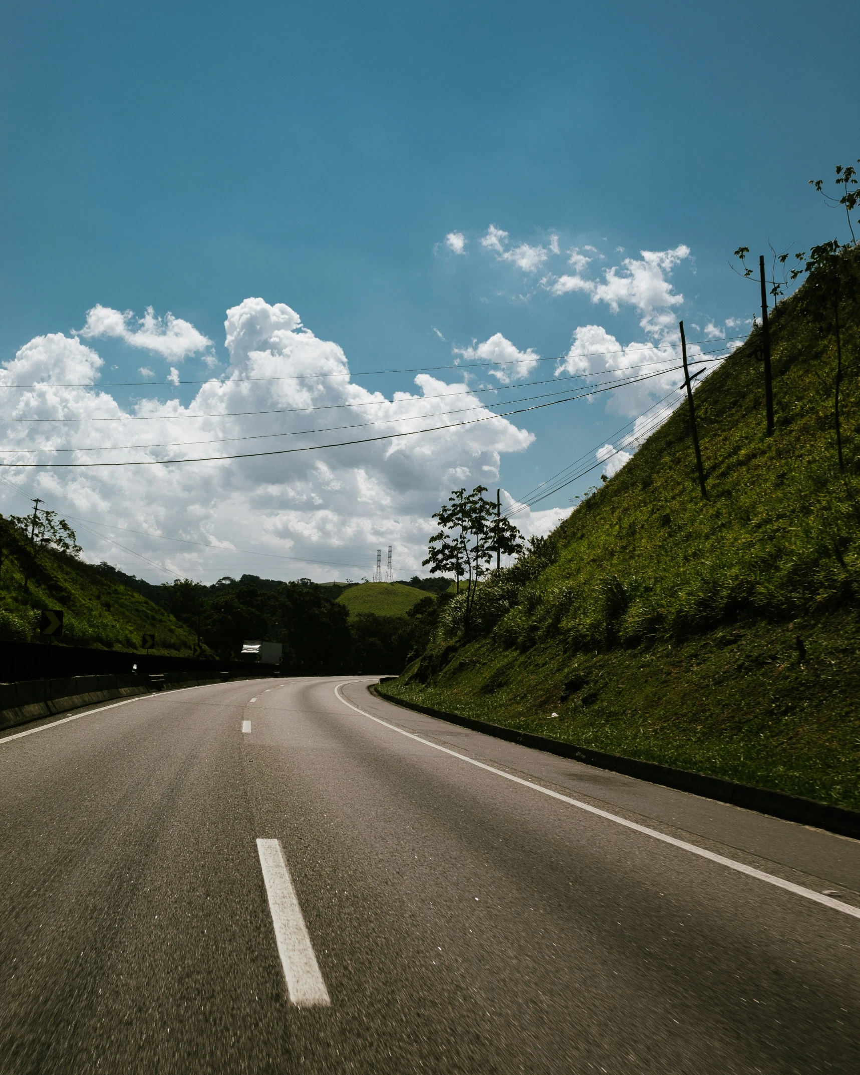 a view from the inside of a vehicle going down the road