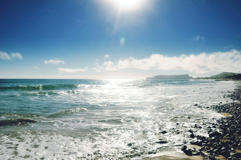 a person on the beach is holding a surfboard