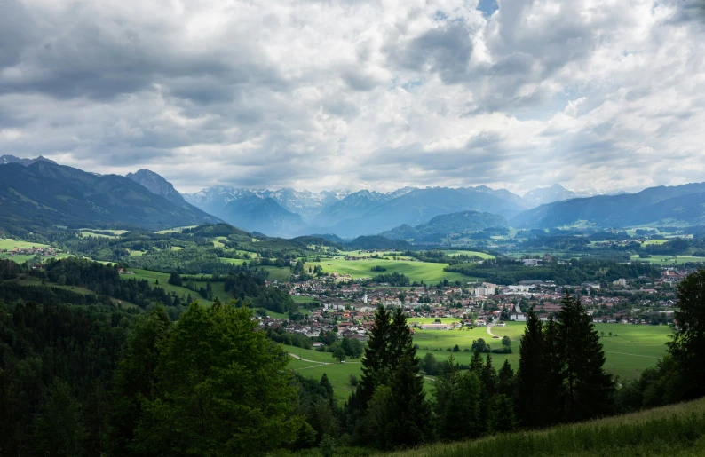 a picturesque valley with large mountains in the distance