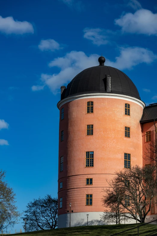 an orange building with a black dome on top