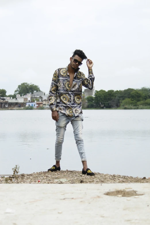 a man stands near a body of water