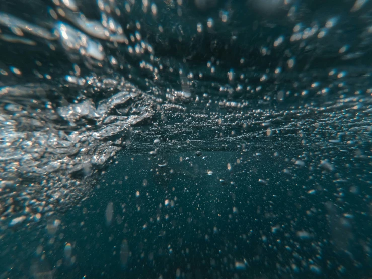 many bubbles of small water floating under the water