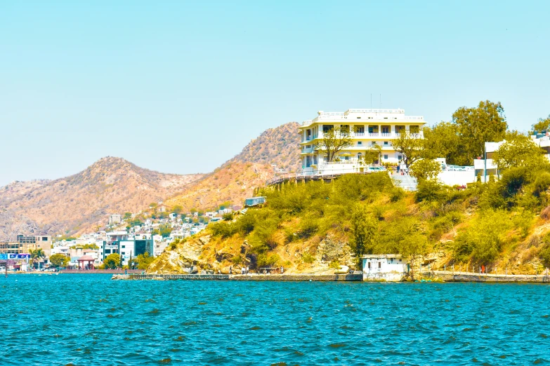 houses overlooking the ocean on the side of the cliff