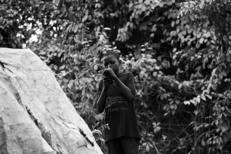 a black and white image of a girl on her phone