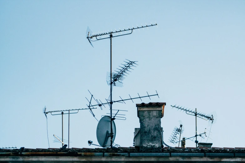 a roof top with many antennas attached to it