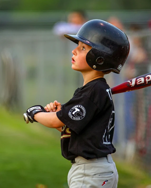 a young baseball player with his bat up