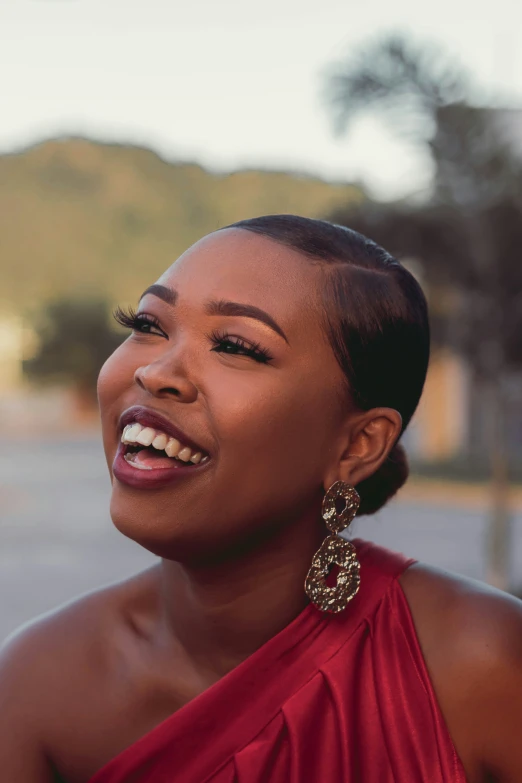 an image of a woman smiling in front of a mountain