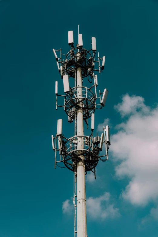 a tall metal pole with many antennas on top