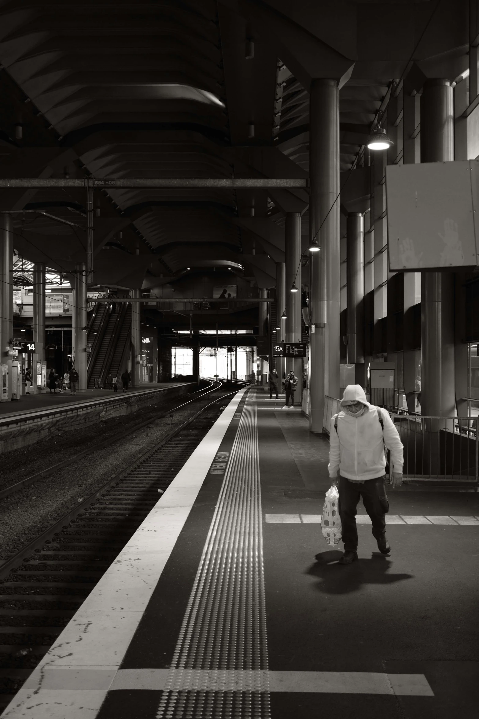 the man is waiting at a train station for his next ride