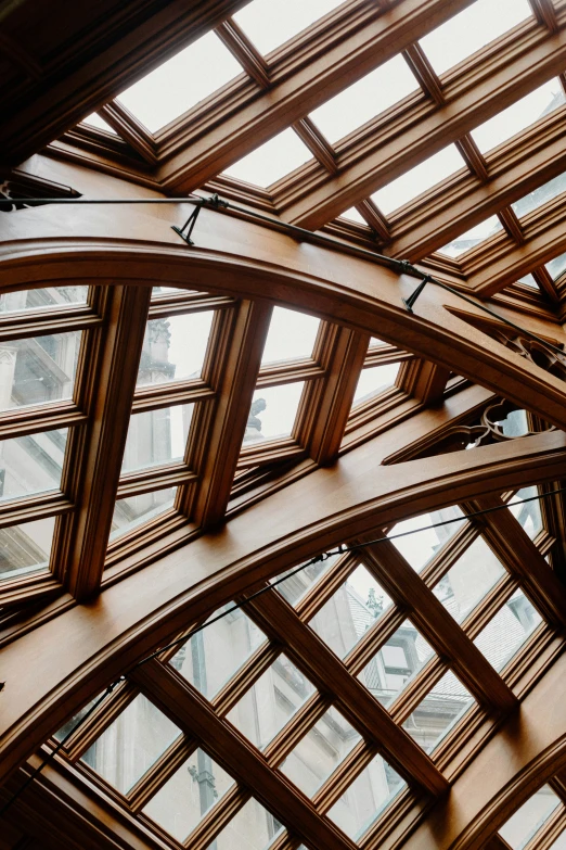 a long vaulted glass and wood room with an ornate ceiling