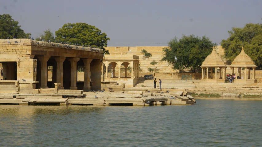 an image of some buildings that are by the water