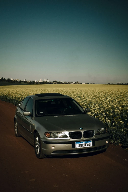 a silver car is parked on the side of the road