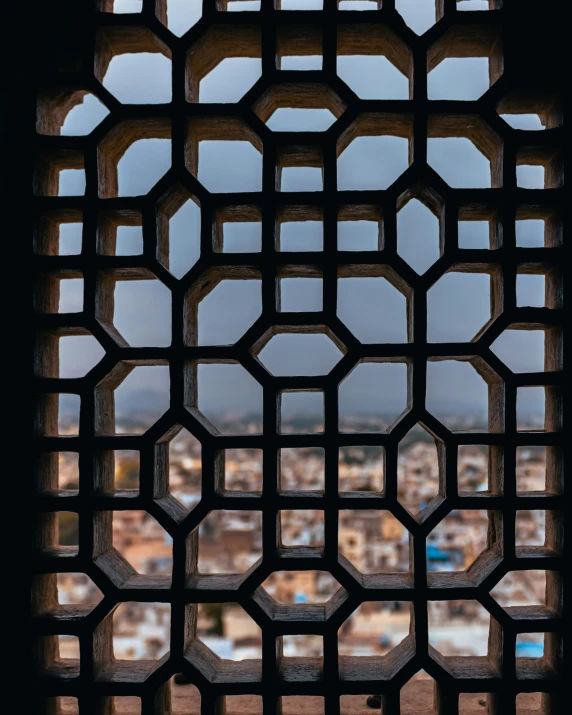 a square shaped window with several hexagonal designs