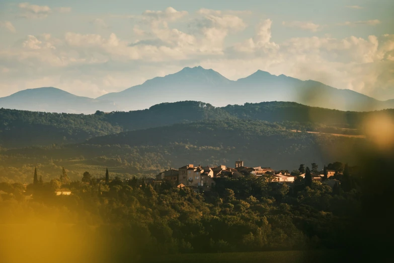 a town on top of a lush green hillside