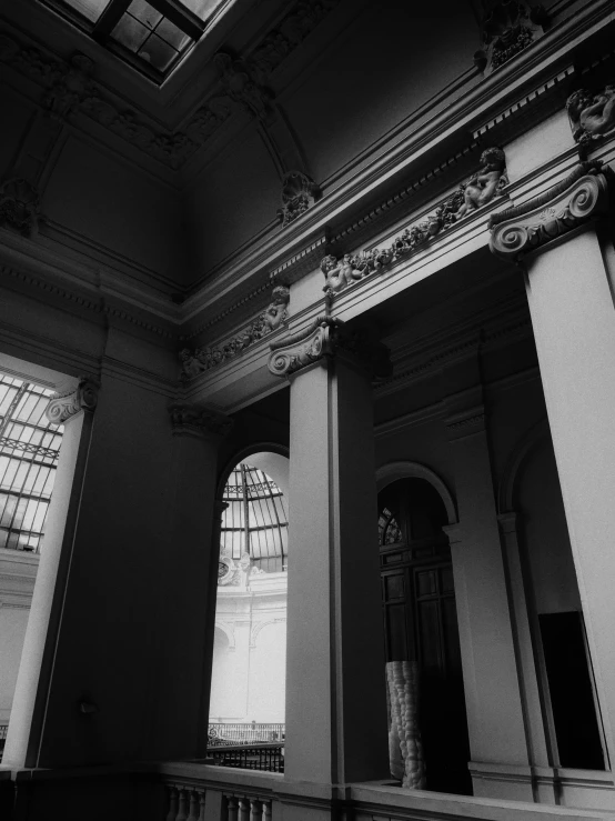 black and white pograph of a woman's feet in a large building