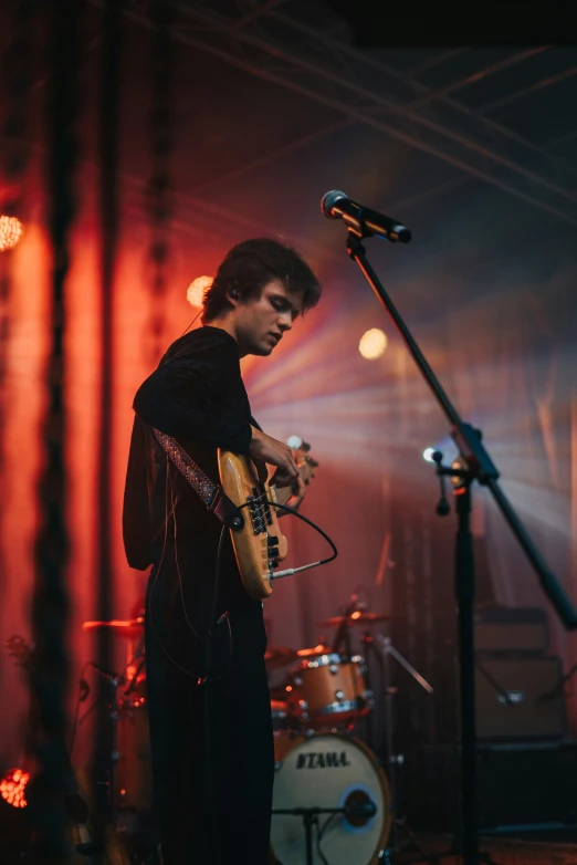 a person on a stage with a guitar