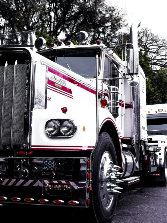 the front of a white truck driving down a road