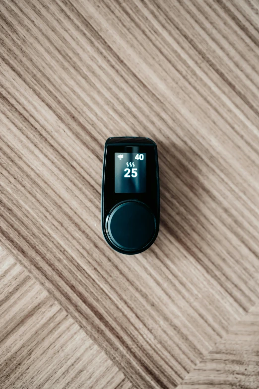 an electronic device with a wooden table in the background